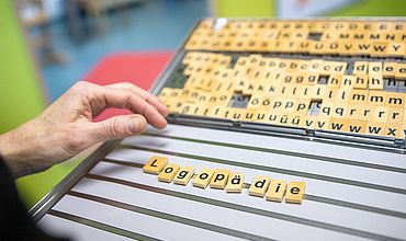 Buchstabenboard mit dem Wort "Logopädie"